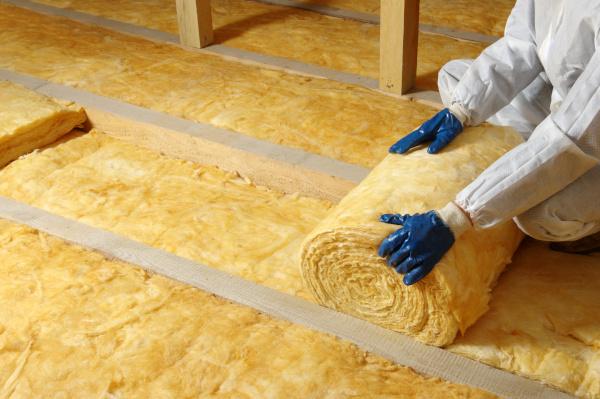 loft insulation being laid in an attic